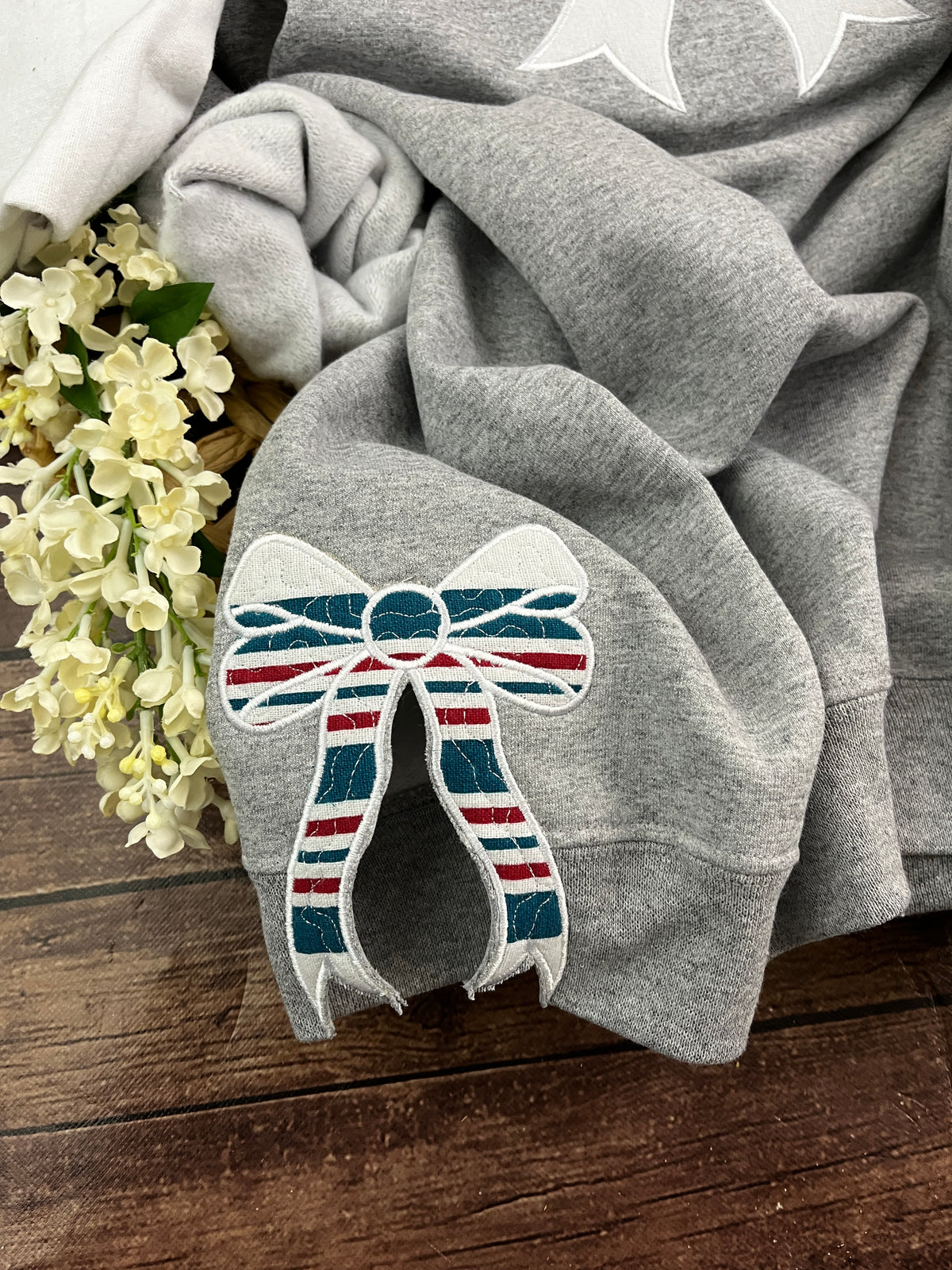 Nurse bow sweatshirt with side bows from a hospital swaddle blanket - close up view