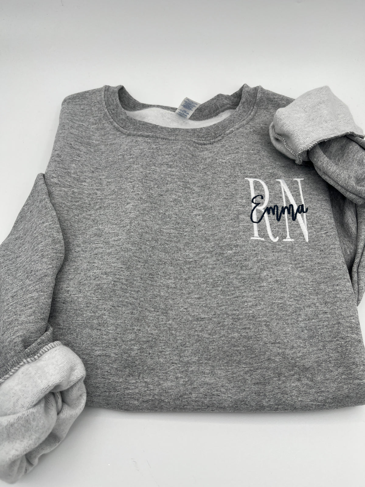 Custom nurse sweatshirt with left chest embroidered name and credentials - detail view