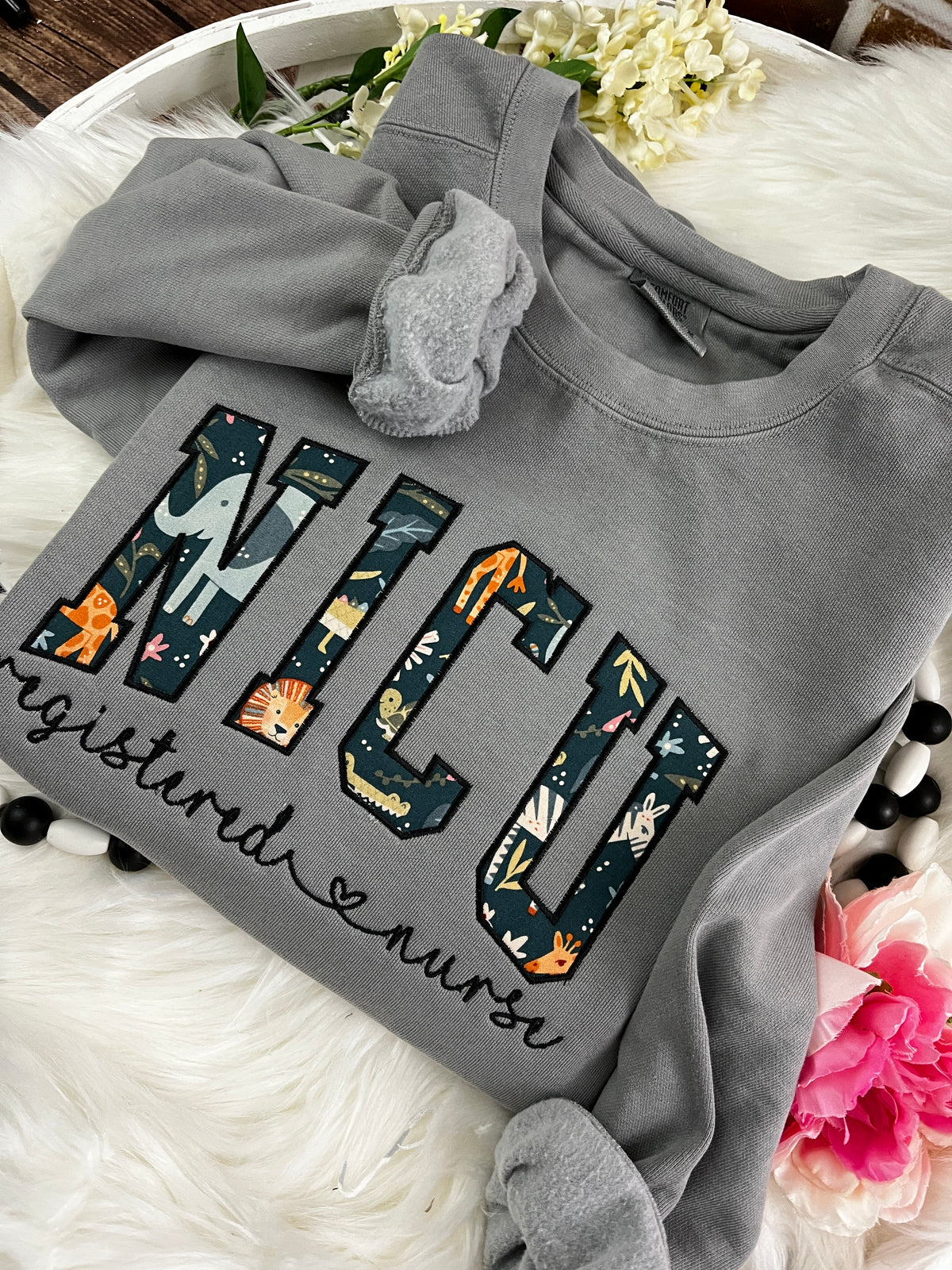 Curved NICU nurse keepsake sweatshirt from a baby swaddle blanket - design close up