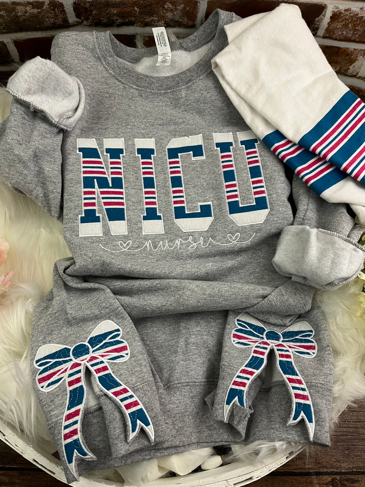 NICU nurse sweatshirt with side bows made from a swaddle blanket