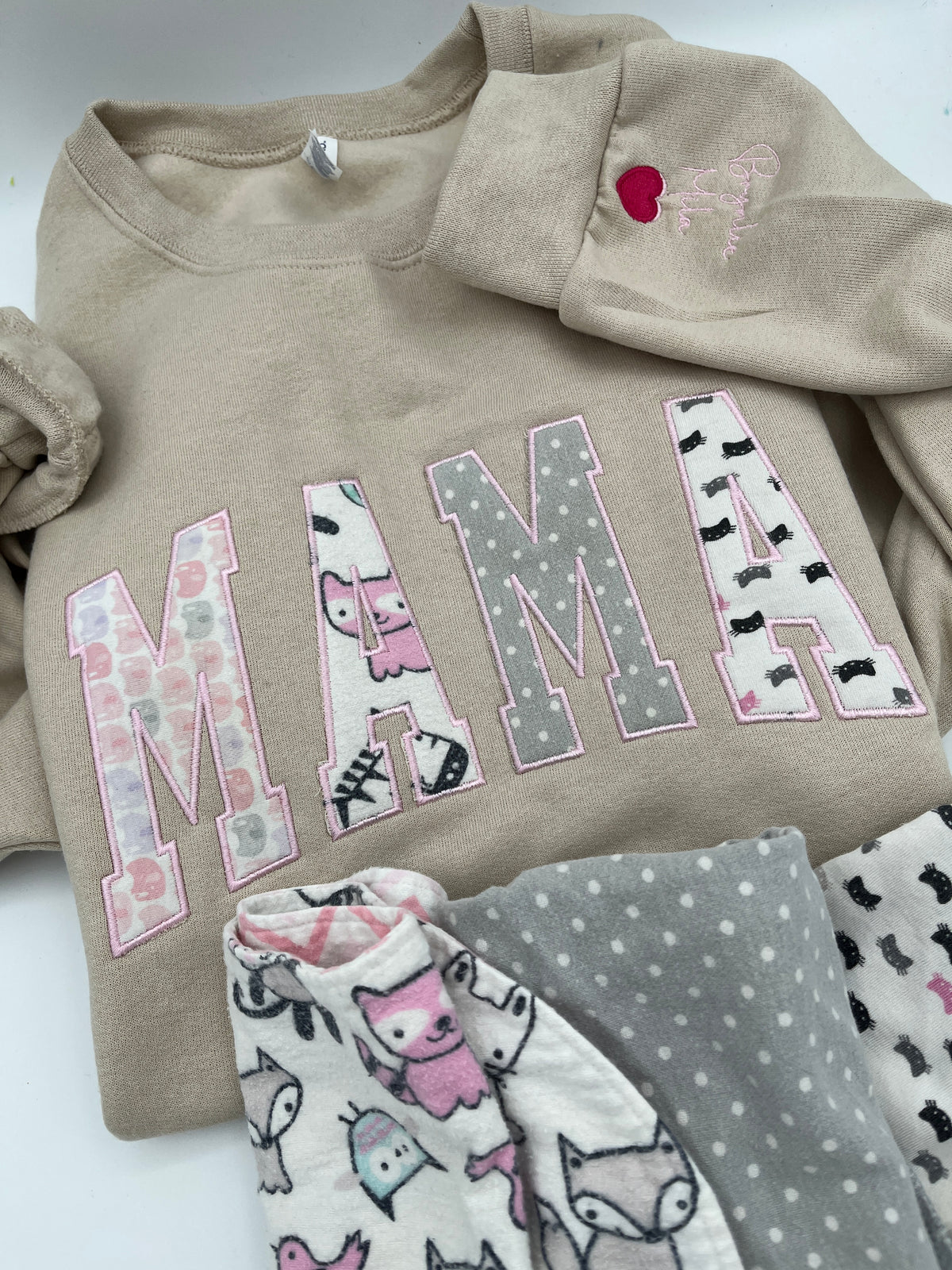 Curved Mama keepsake sweatshirt appliqued from baby clothes - detail view