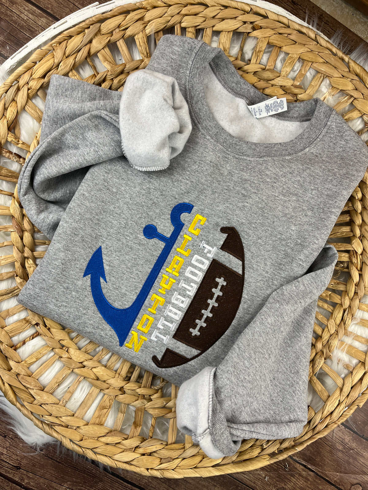 Football sweatshirt with embroidered half anchor and half ball design - detail view