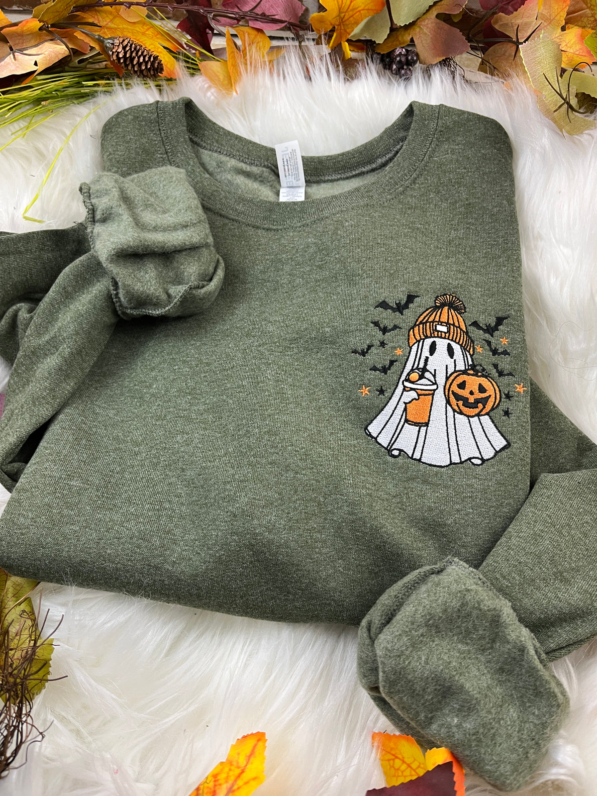 Embroidered spooky ghost sweatshirt with iced latte and orange beanie - detail view