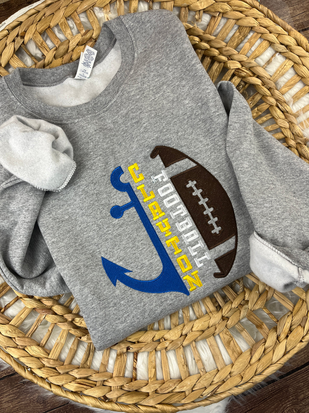 Football sweatshirt with embroidered half anchor and half ball design
