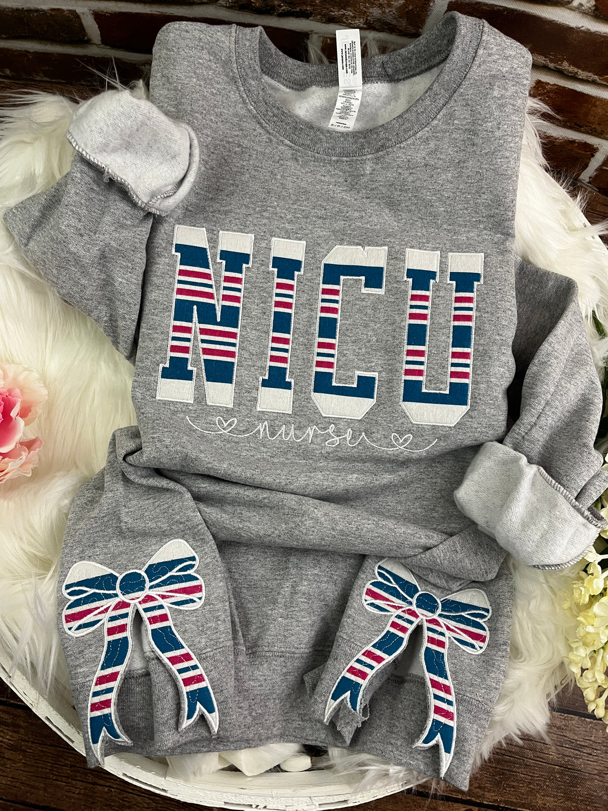 NICU nurse sweatshirt with side bows made from a swaddle blanket - design close up