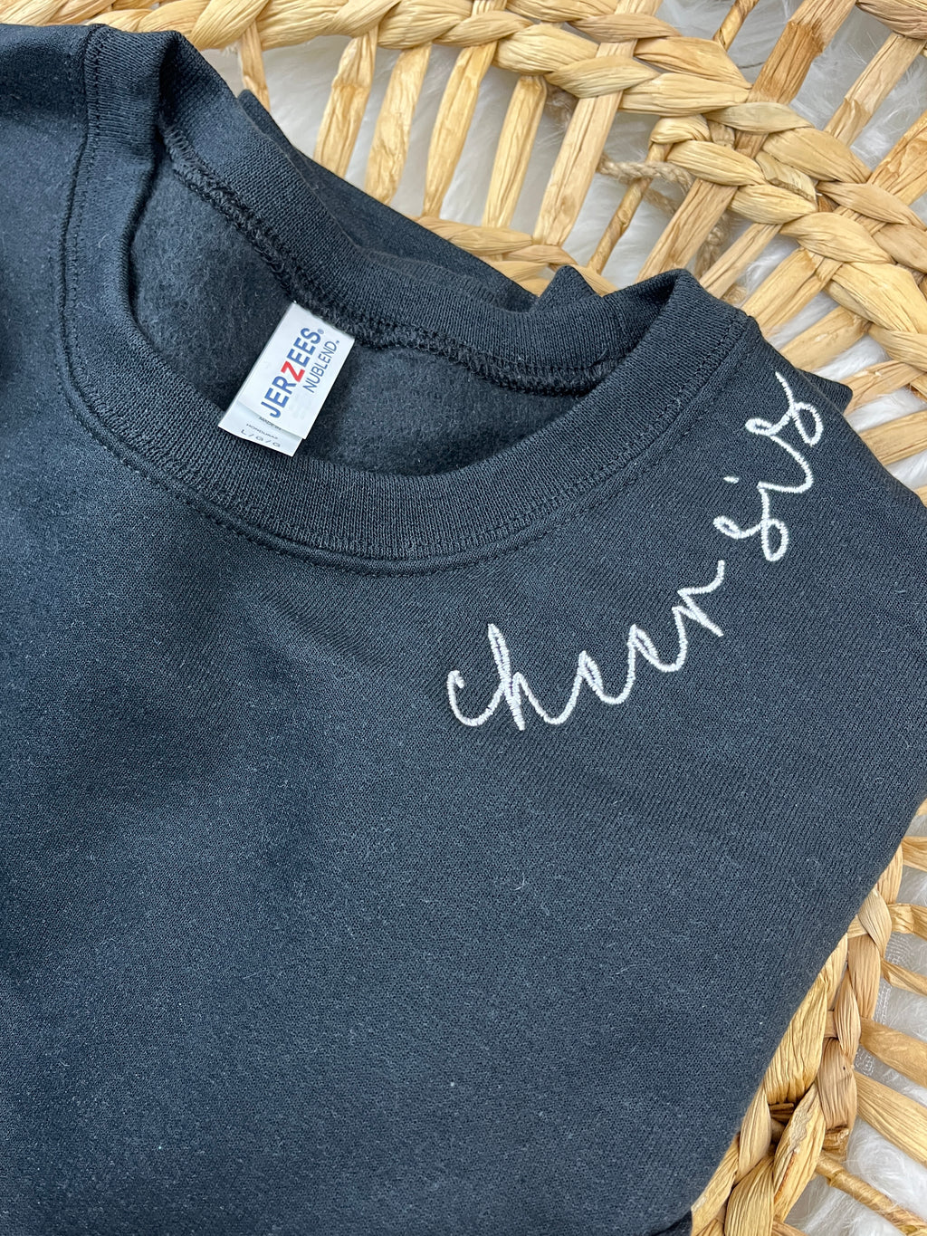 Custom sweatshirt with cursive name embroidery along the collar - detail view