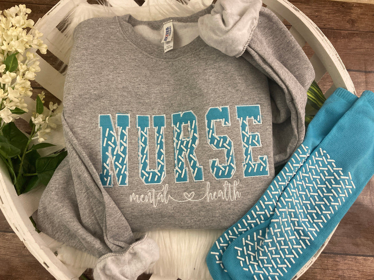 Nurse sweatshirt with grippy sock applique design