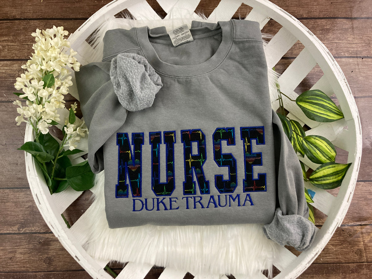 Nurse sweatshirt with rainbow heartbeat fabric applique - detail view