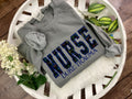 Nurse sweatshirt with rainbow heartbeat fabric applique