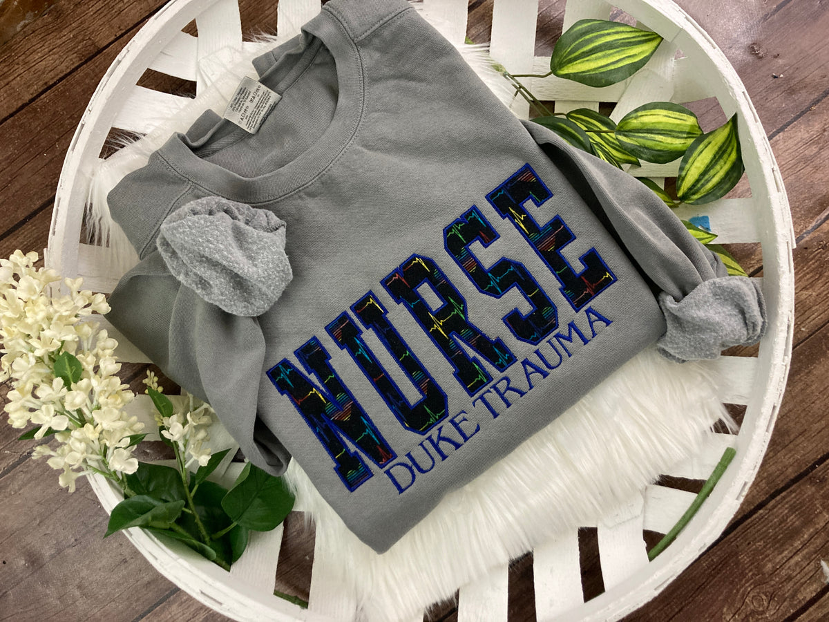 Nurse sweatshirt with rainbow heartbeat fabric applique