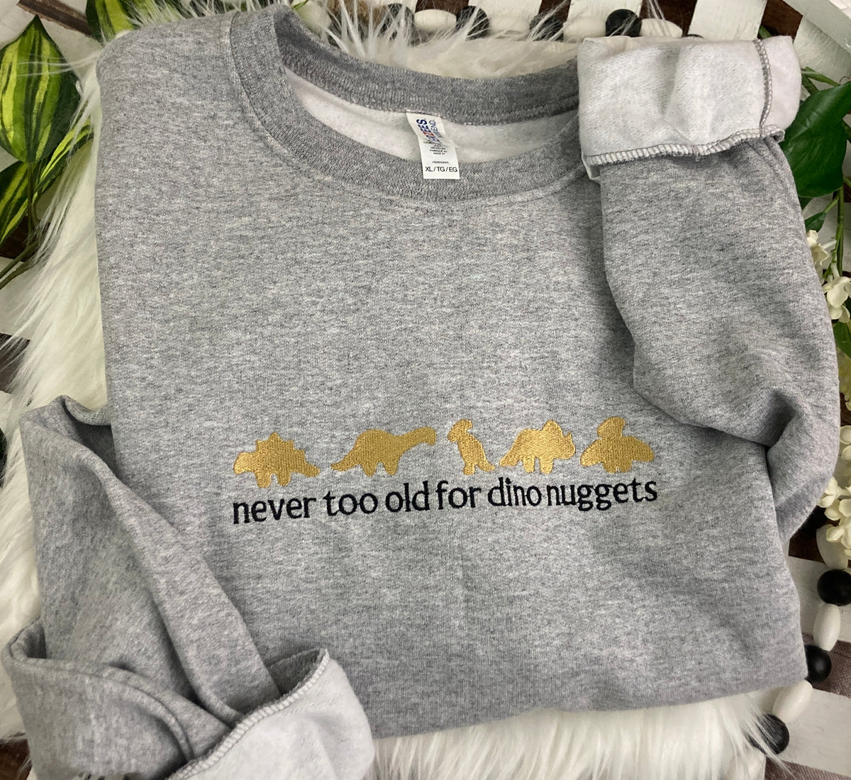 Never too old for dino nuggets embroidered sweatshirt - detail view