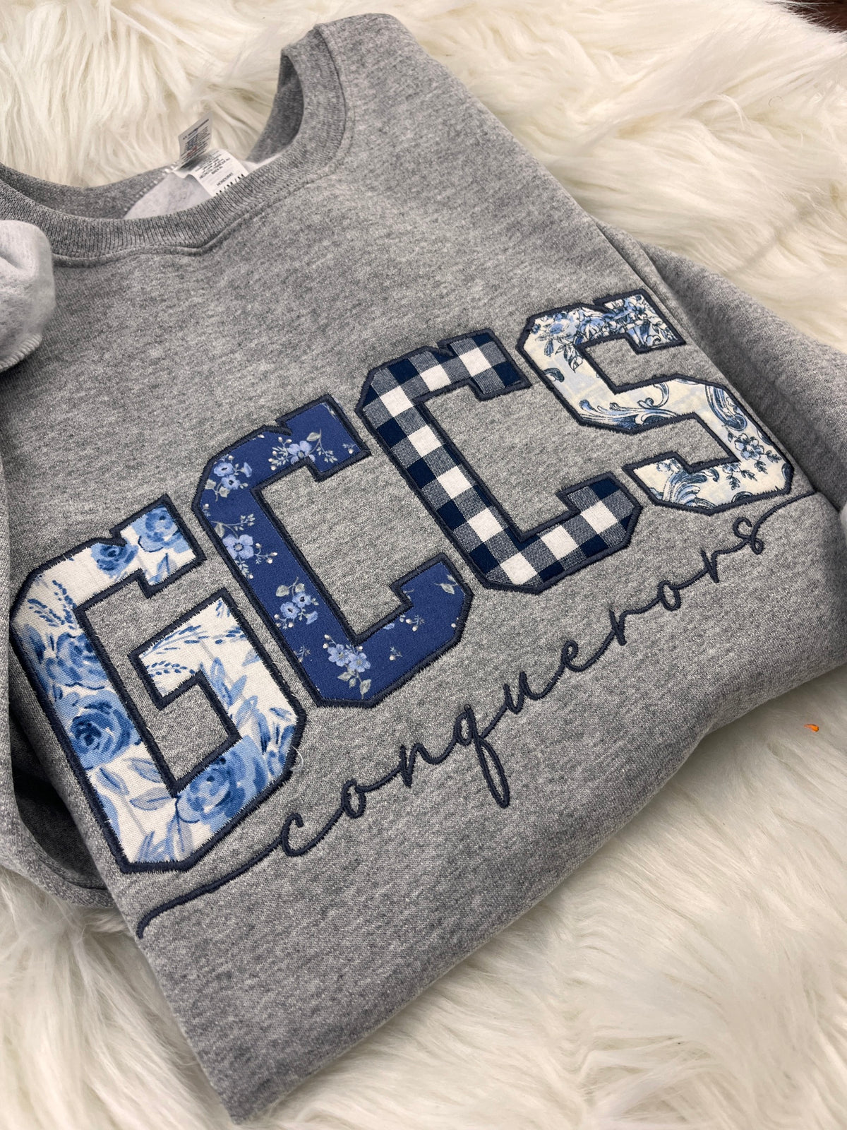 GCCS Conquerors appliqué crewneck sweatshirt, mixed blue fabric letters with navy script