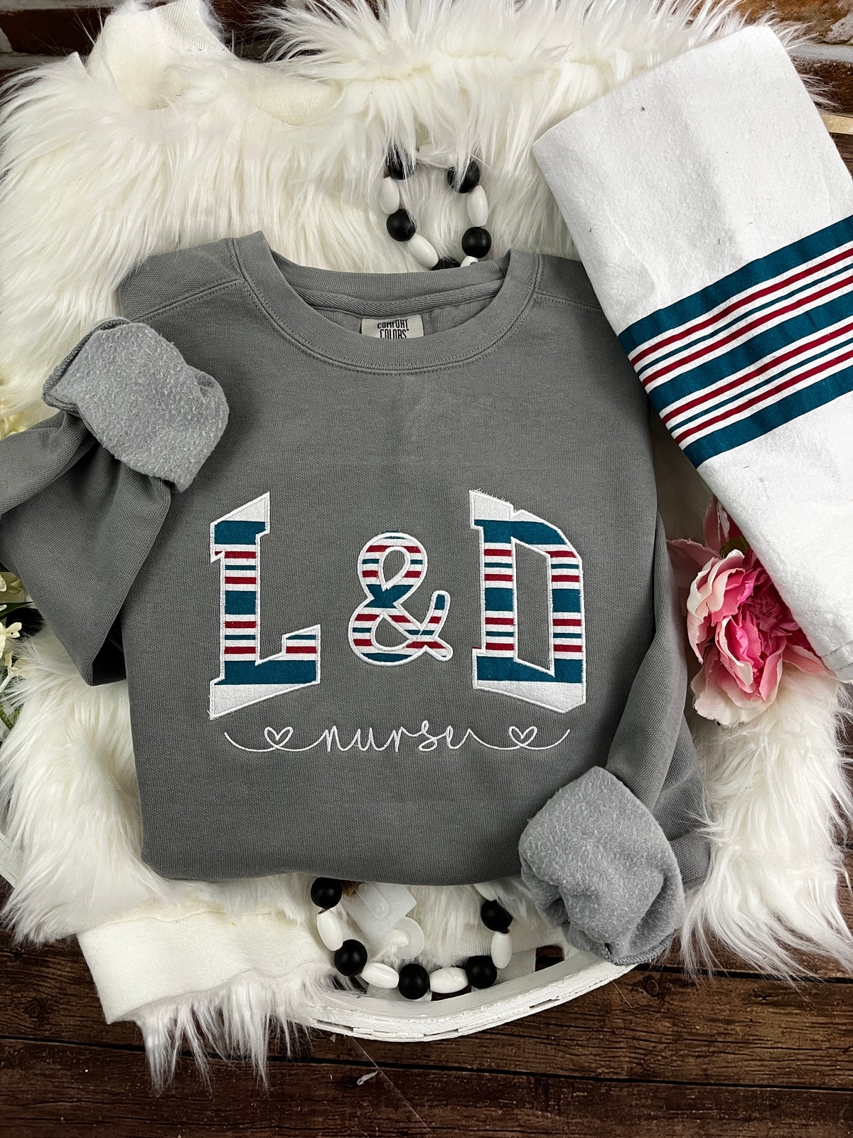 Curved labor and delivery nurse keepsake sweatshirt from swaddle blanket - design close up