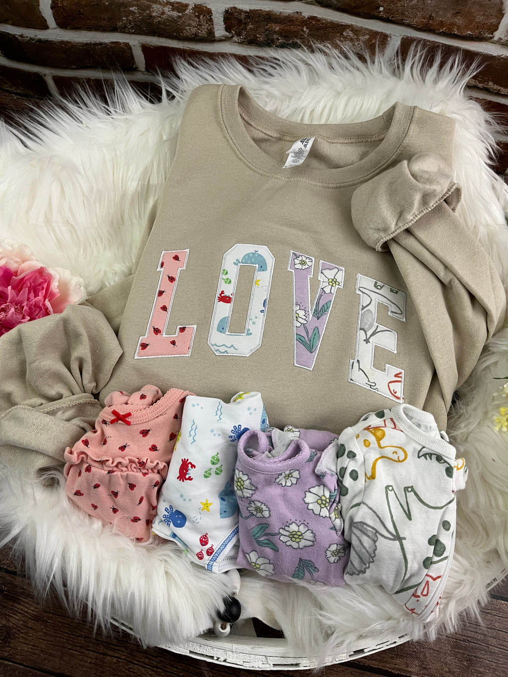 Curved love keepsake sweatshirt appliqued from baby clothes - detail view