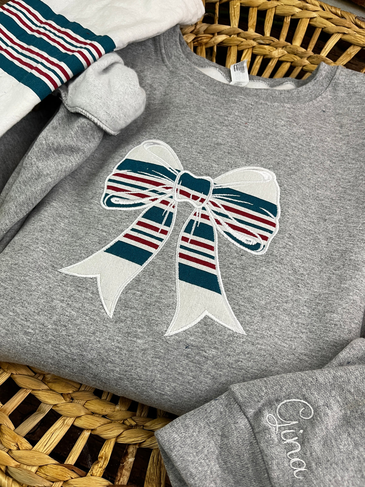 Nurse bow sweatshirt appliqued from a baby hospital swaddle blanket - second detail view