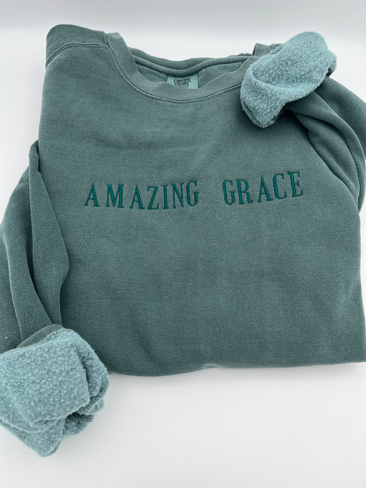 Amazing Grace embroidered hymn Christian sweatshirt - close up view
