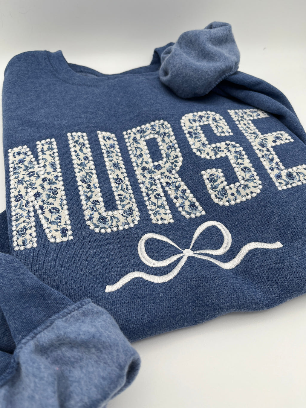 Coquette nurse sweatshirt with applique and embroidered bow - detail view