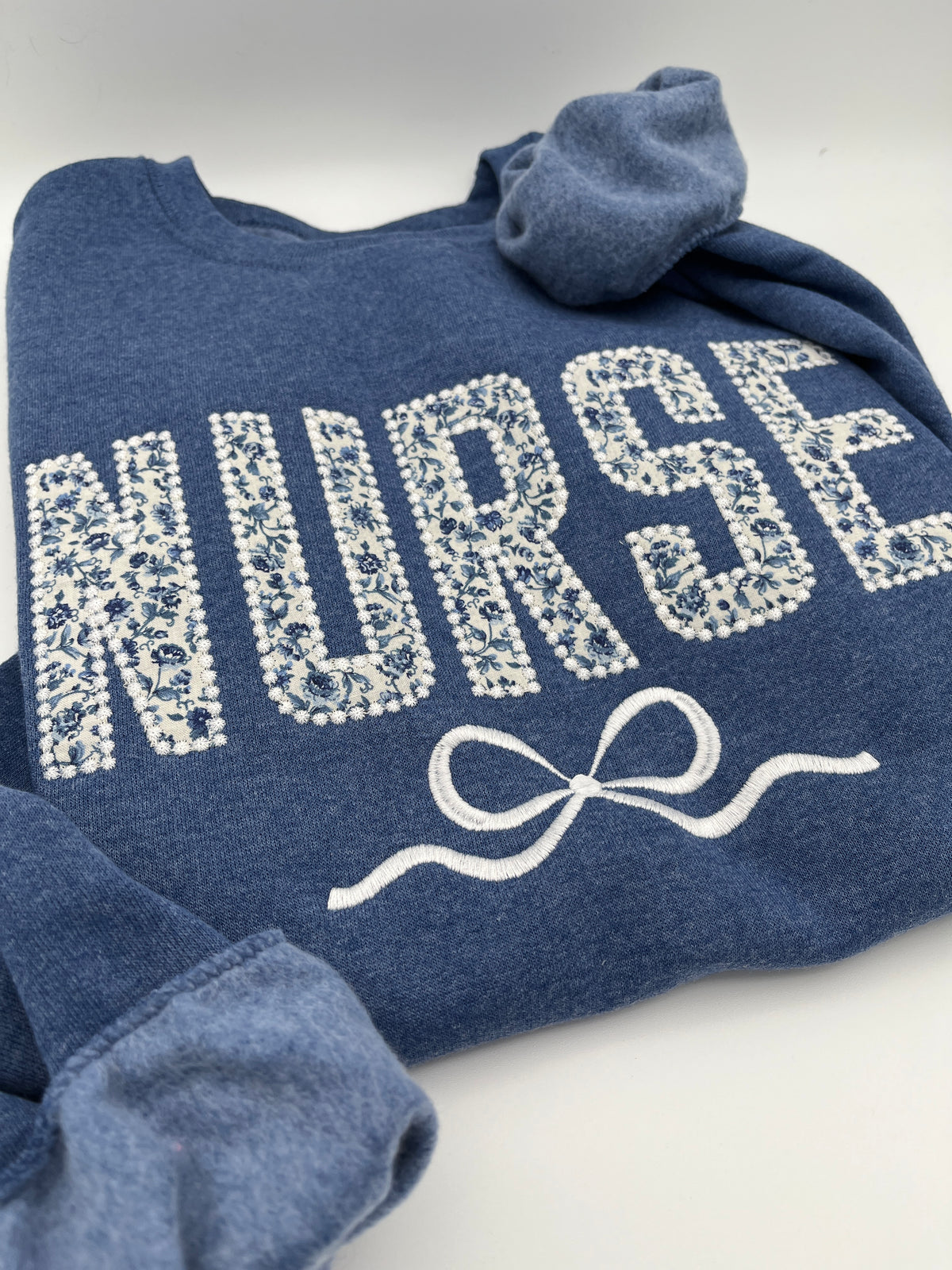Coquette nurse sweatshirt with applique and embroidered bow - detail view