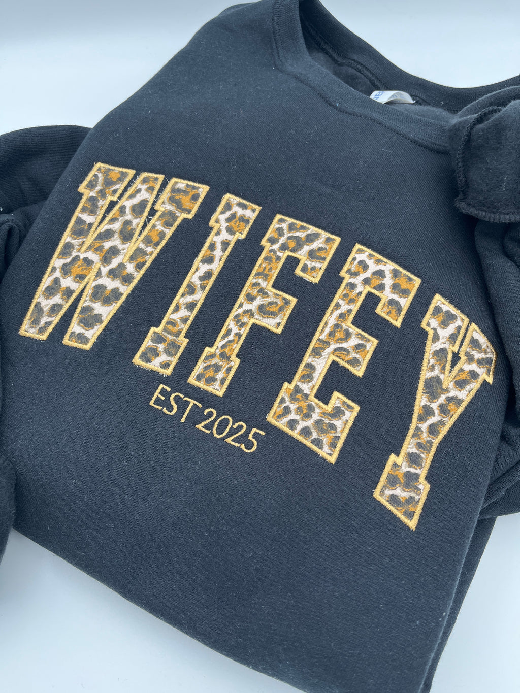 Curved WIFEY applique sweatshirt with cheetah print lettering and custom year - detail view