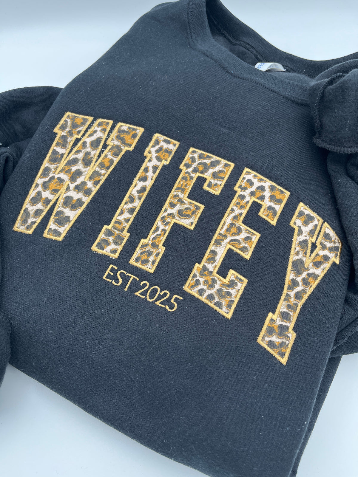 Curved WIFEY applique sweatshirt with cheetah print lettering and custom year - detail view