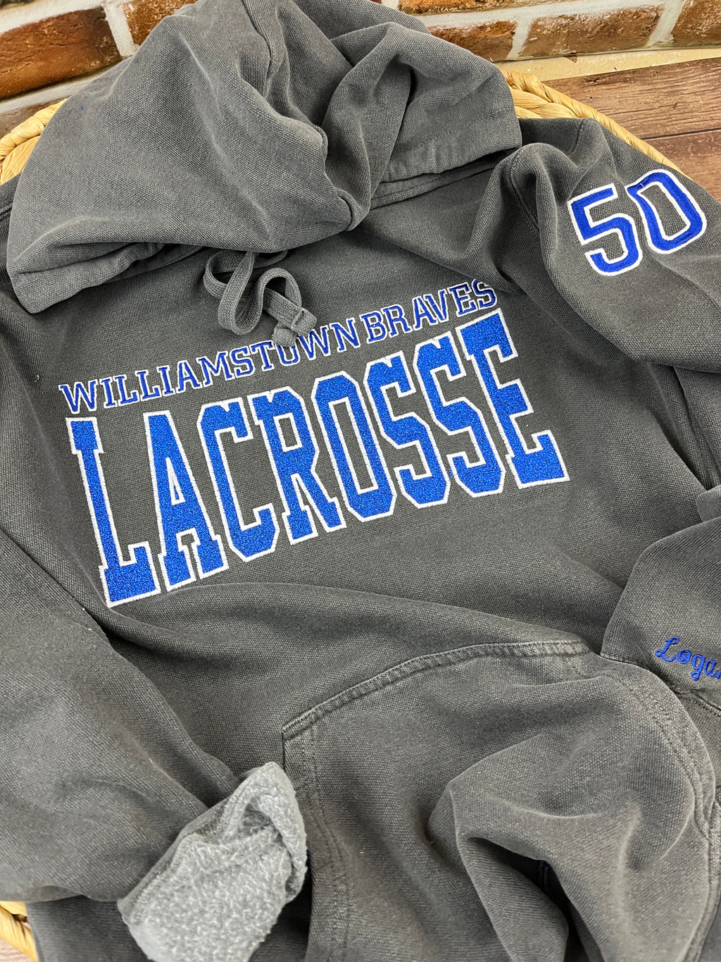 Custom lacrosse sweatshirt with glitter applique school name embroidery - detail view