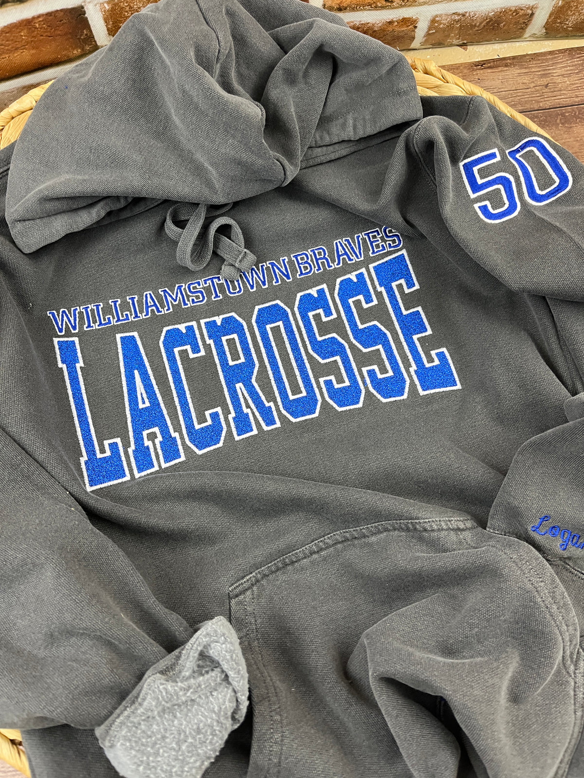 Custom lacrosse sweatshirt with glitter applique school name embroidery - detail view