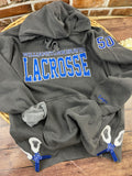 Custom lacrosse sweatshirt with glitter applique school name embroidery
