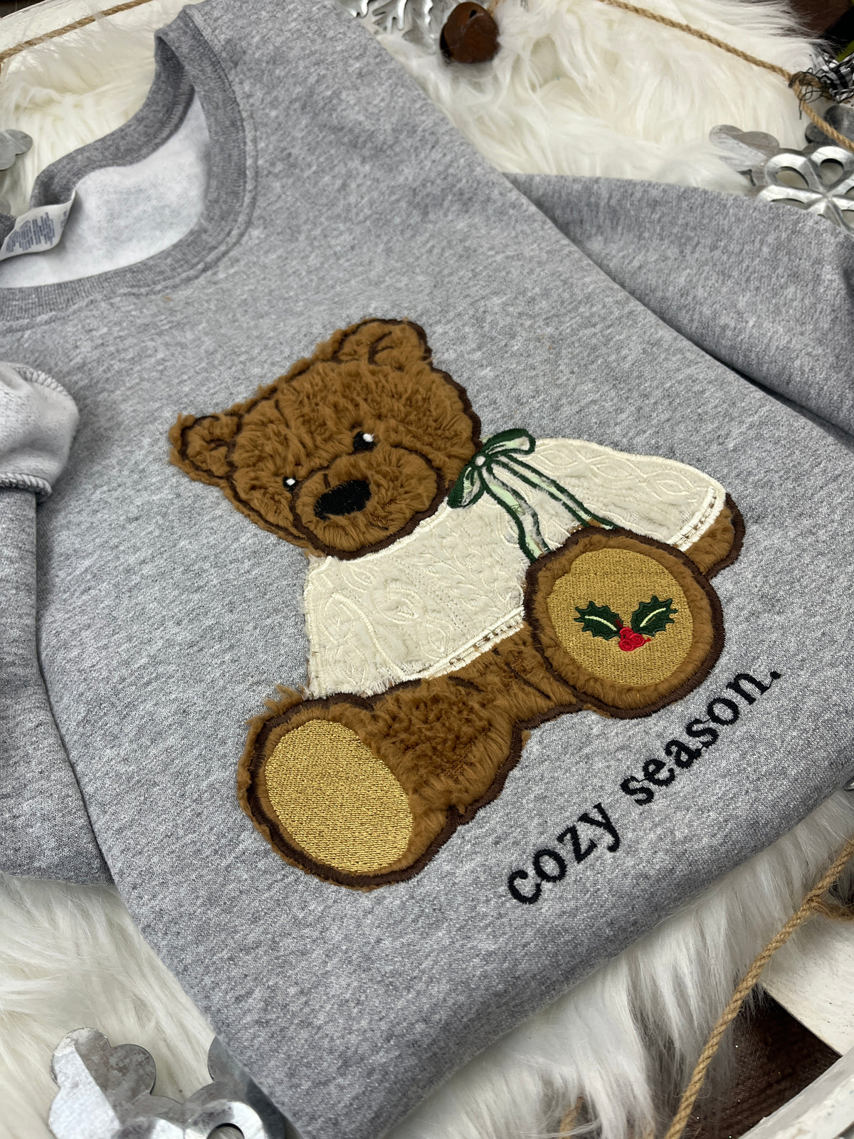 Christmas bear sweatshirt with brown sherpa applique and holly paw design - detail view 2