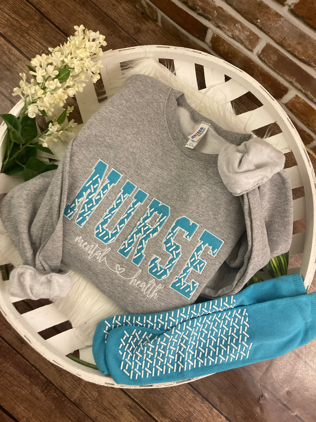 Nurse sweatshirt with grippy sock applique design - detail view