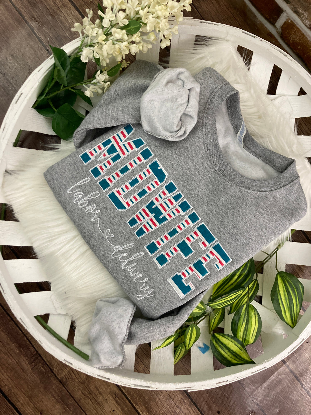 Midwife keepsake sweatshirt appliqued from a baby hospital blanket - close up view