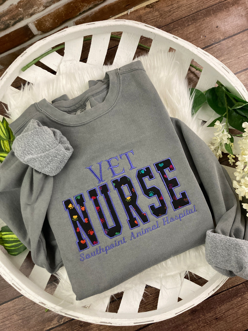 Vet nurse embroidered sweatshirt with rainbow paw print applique - design close up