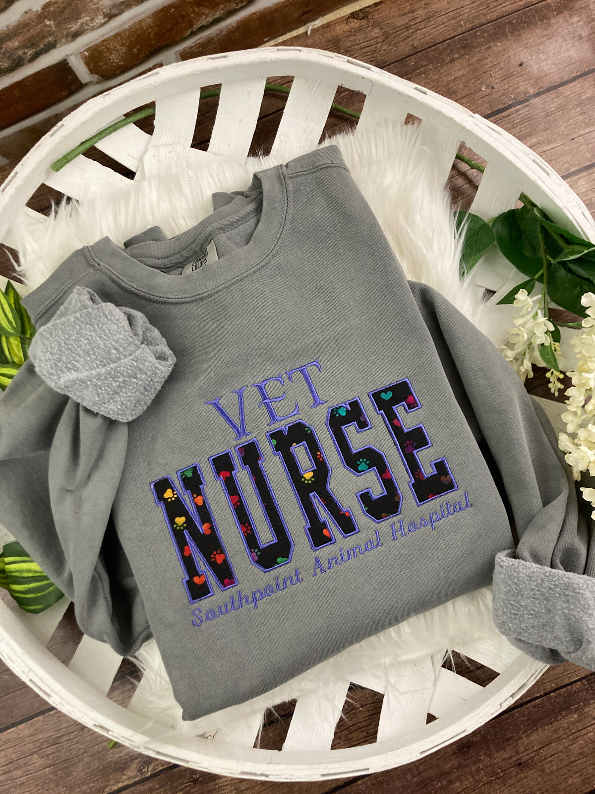 Vet nurse embroidered sweatshirt with rainbow paw print applique - design close up