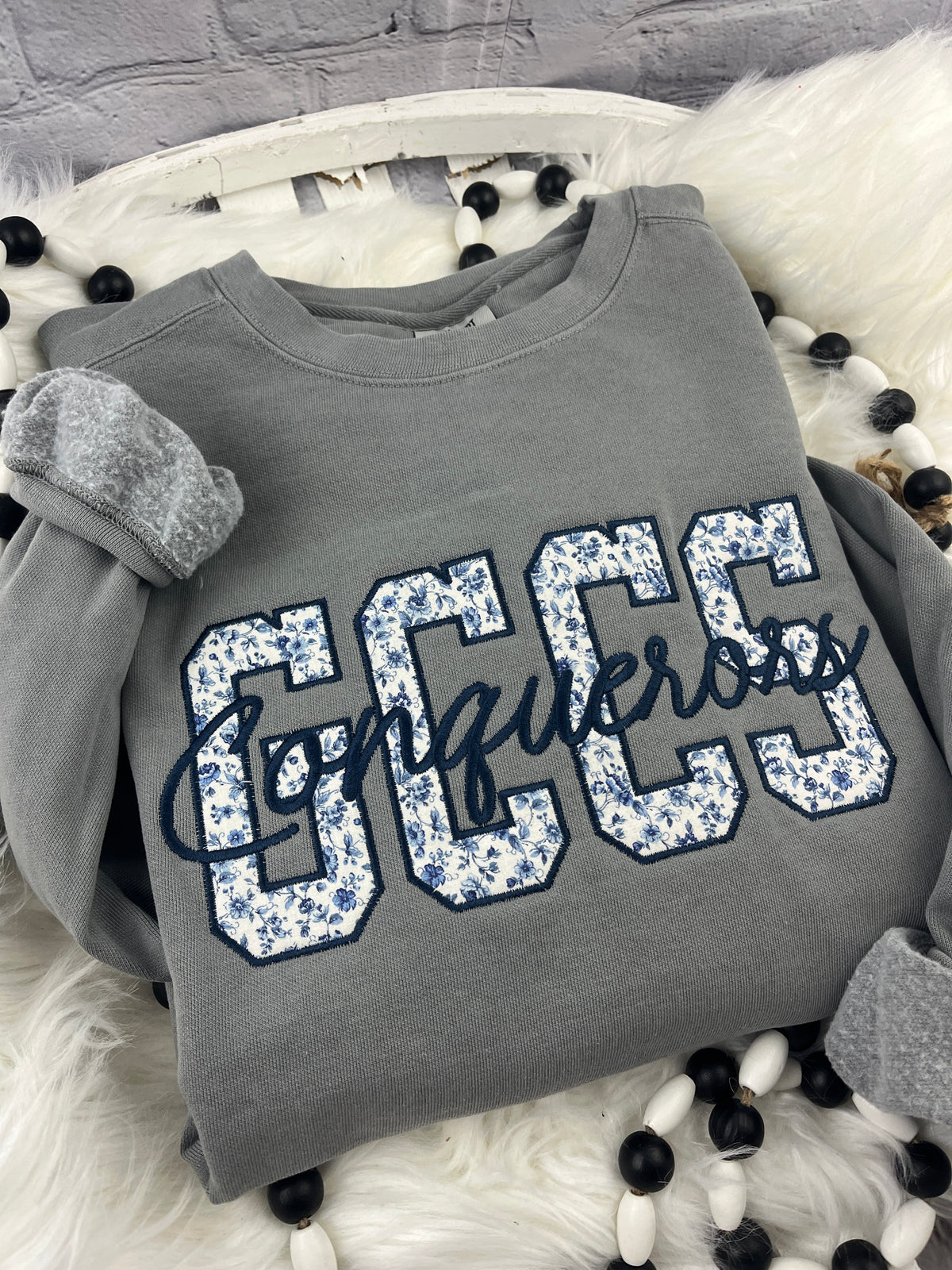 School spirit sweatshirt with floral blue applique and cursive script - detail view 2