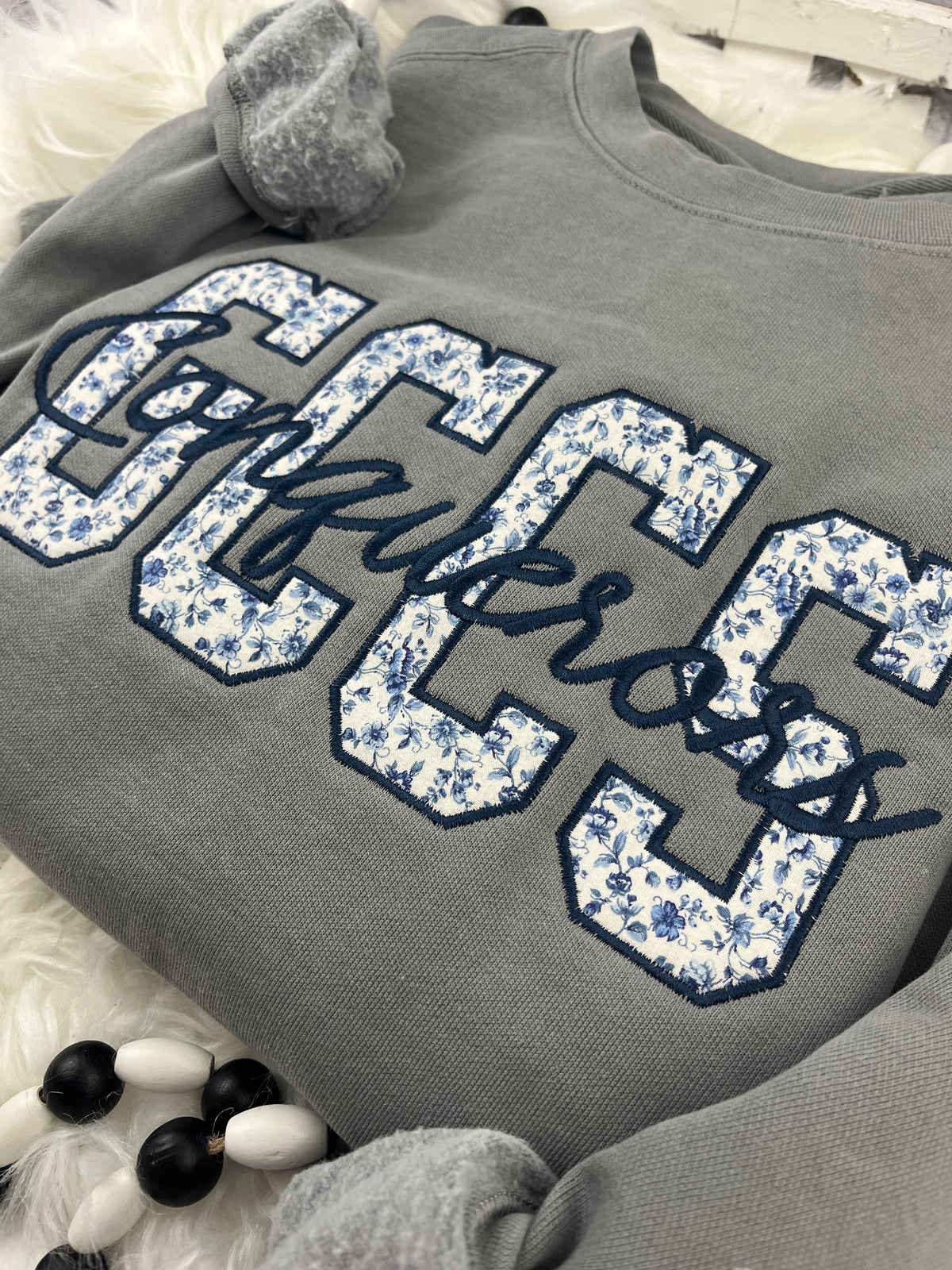 School spirit sweatshirt with floral blue applique and cursive script - detail view 4