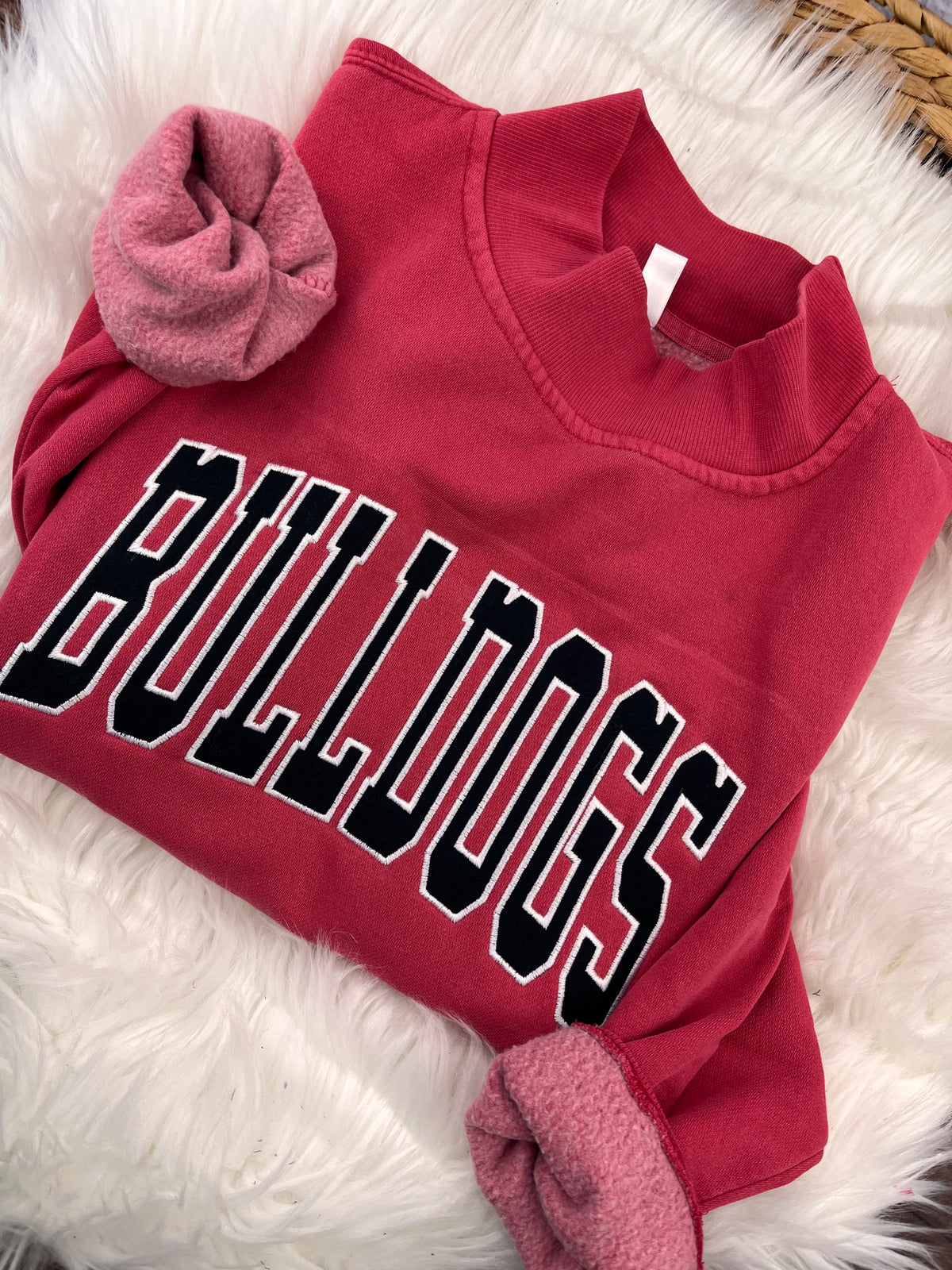Red mock neck sweatshirt with black BULLDOGS applique letters