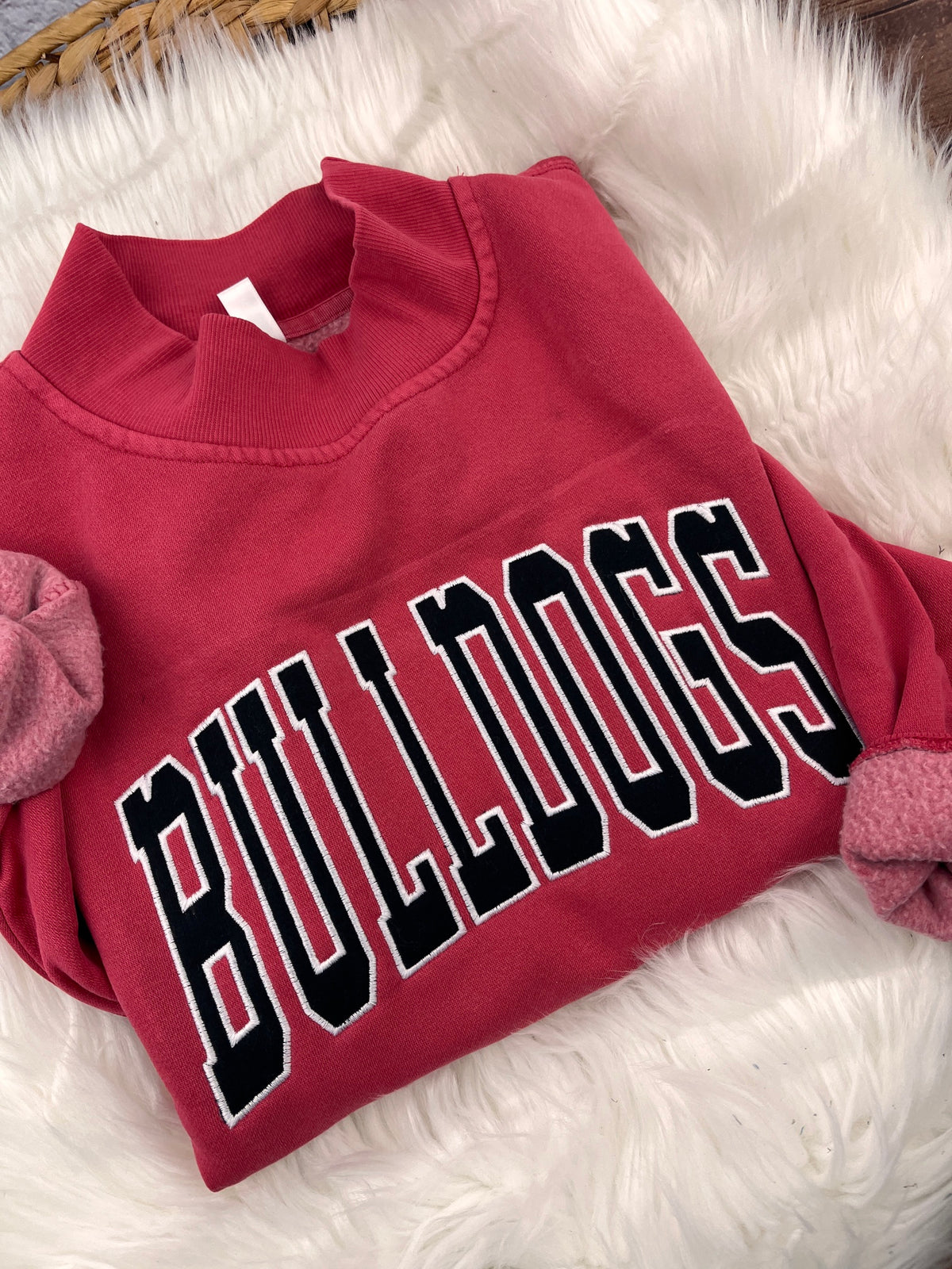 Red mock neck sweatshirt with black BULLDOGS applique letters