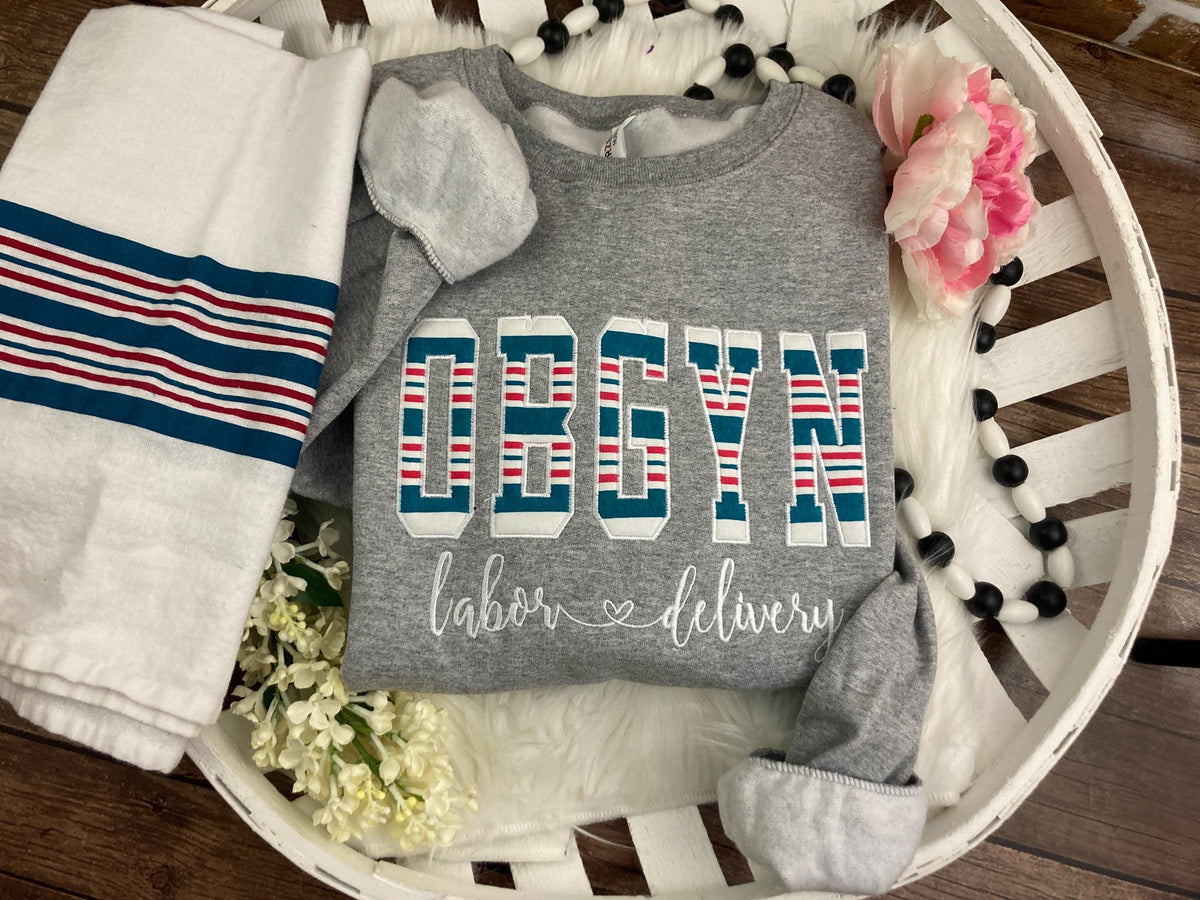 OBGYN keepsake sweatshirt appliqued from a baby hospital swaddle blanket - detail view
