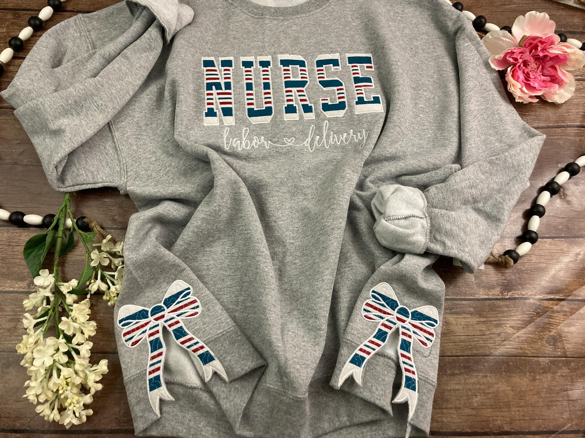 Nurse keepsake sweatshirt with side bows made from a baby hospital swaddle blanket