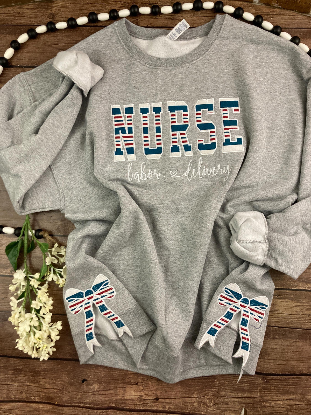 Nurse keepsake sweatshirt with side bows made from a baby hospital swaddle blanket - detail view